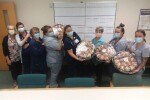 Famel Nurses Holding Up Cookie Trays
